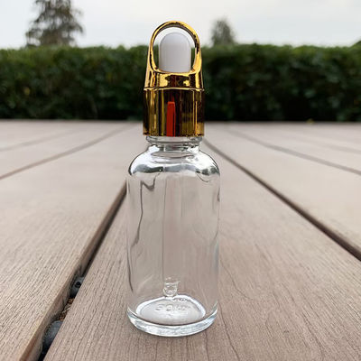 Doorzichtige glazen dropperfles met gouden dop